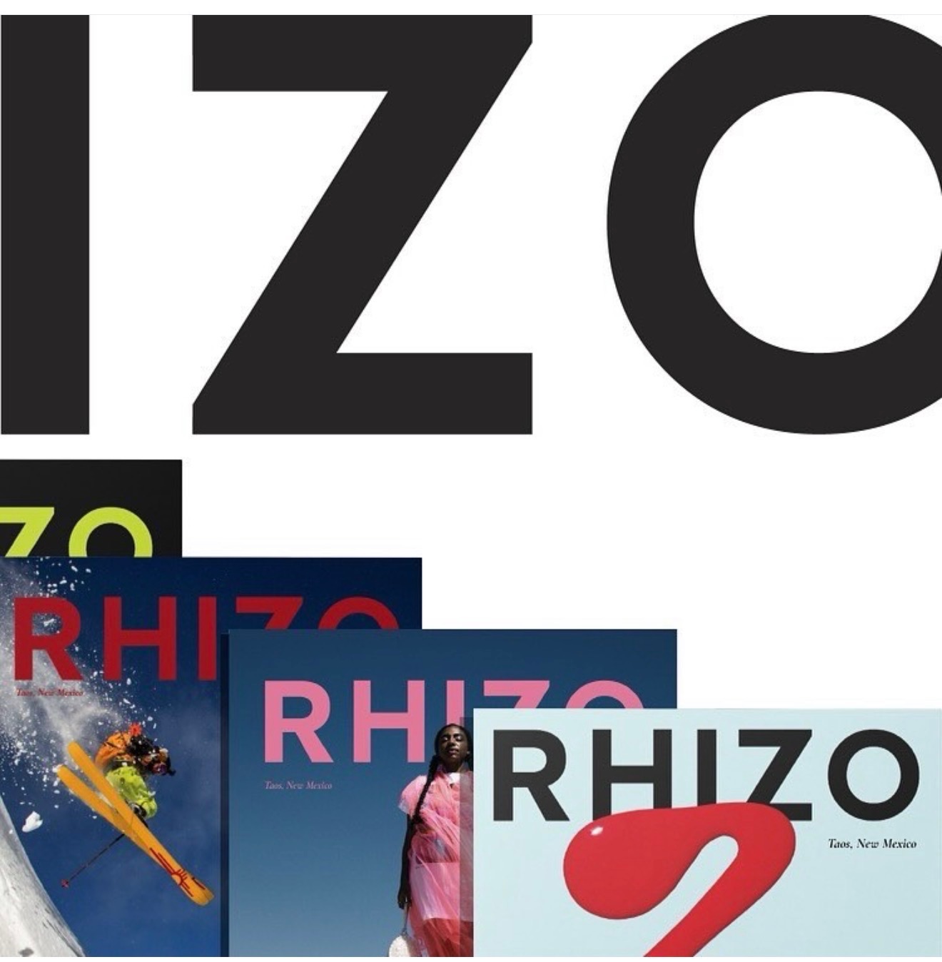 RHIZO typography over a stack of magazine issue covers